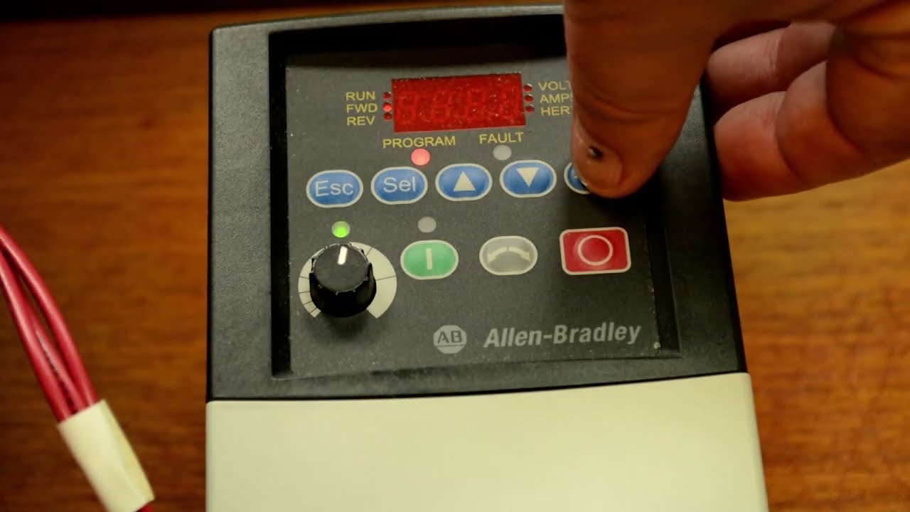Engineer adjusting an Allen-Bradley drive during troubleshooting.